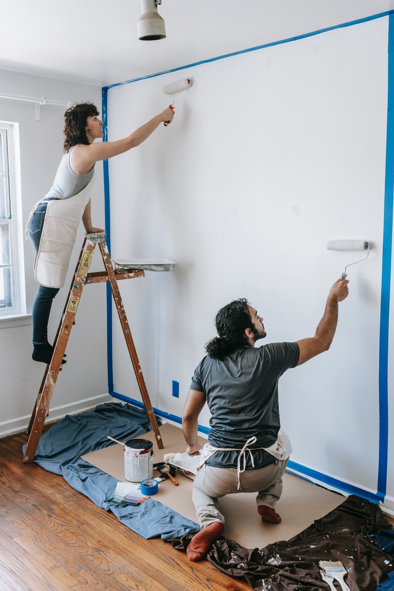 couple painting white wall